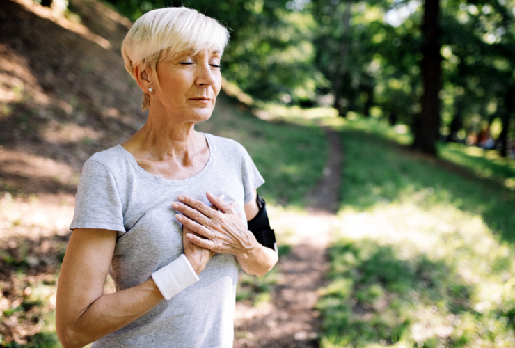 Woman with chest pain suffering from heart attack during running